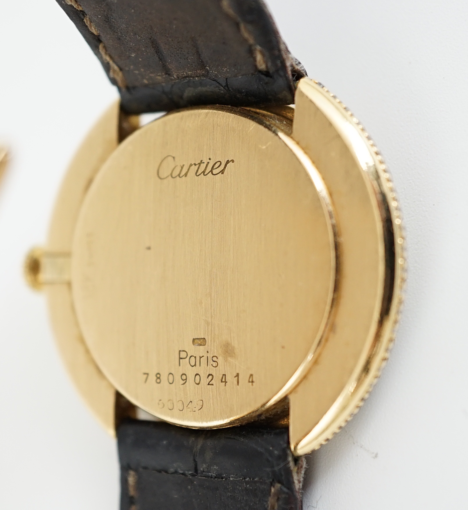 A lady's 18ct gold, black onyx and diamond set Cartier Vendome manual wind wrist watch